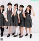 A group of young women in school uniforms posing for a picture.